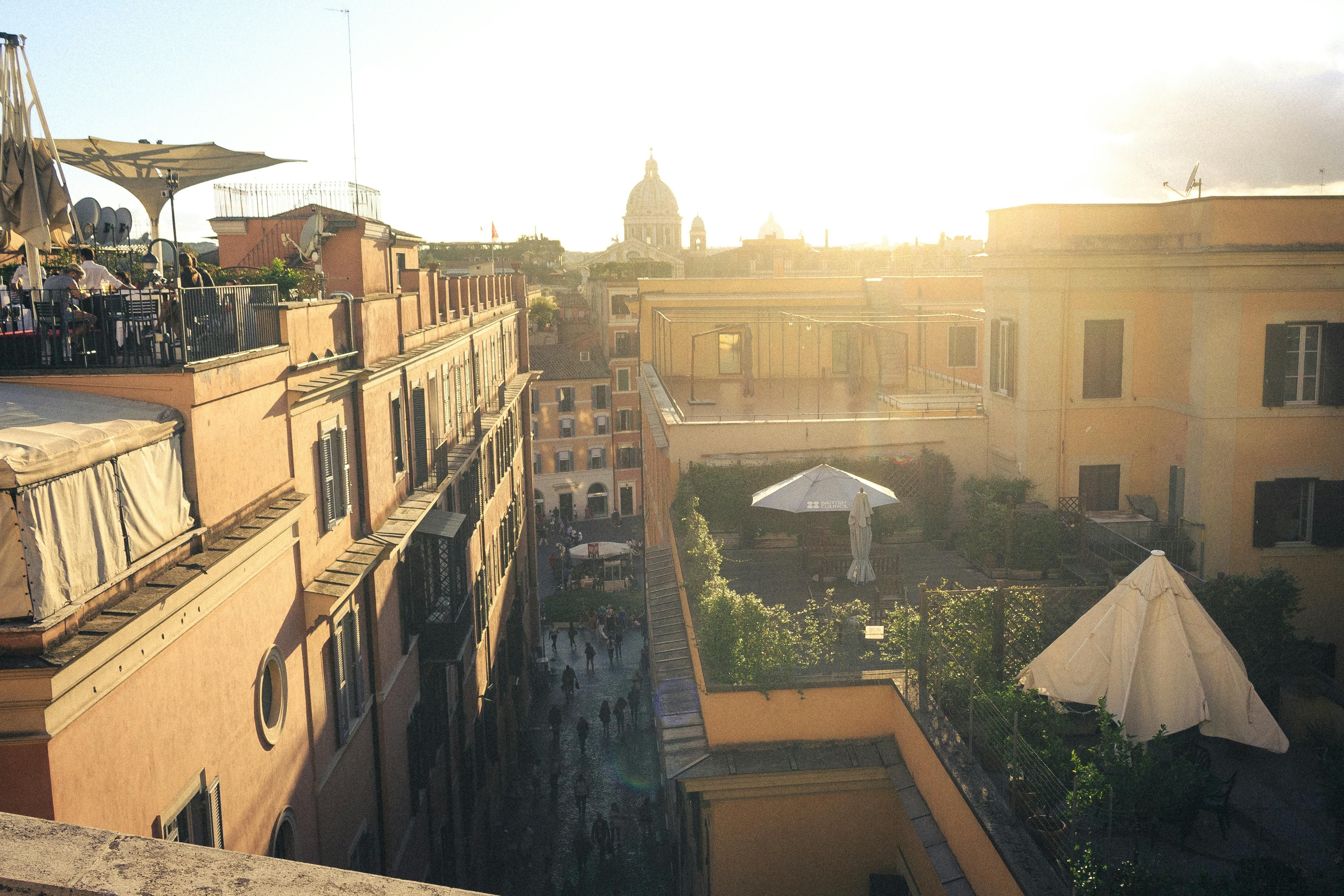 Rooftop terrace view over Roman rooftops at golden hour from Hotel Colle Oppio