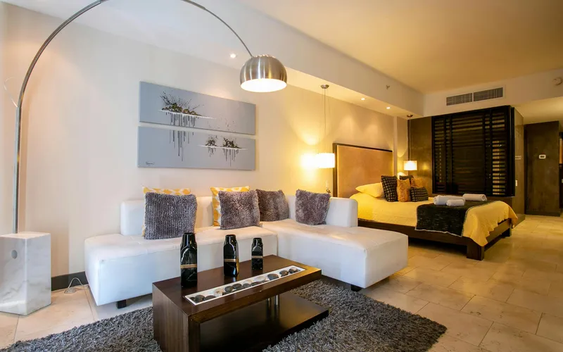 A 22-square-metre Superior Room at Hotel Colle Oppio in Rione Monti, with a queen bed, seating area, and luggage rack — the room category we recommend for families and stays of a week or more.